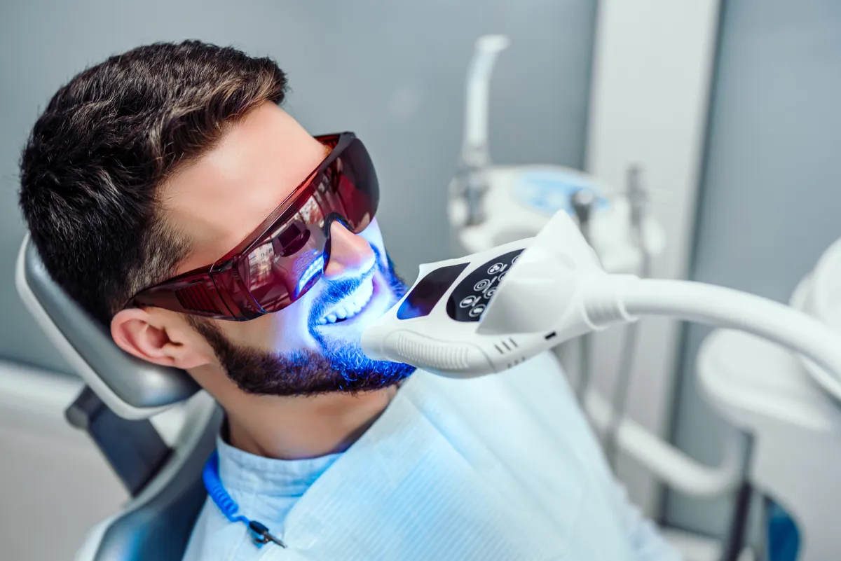Patient receiving professional LED teeth whitening treatment at Studio One Dental in Humble, TX