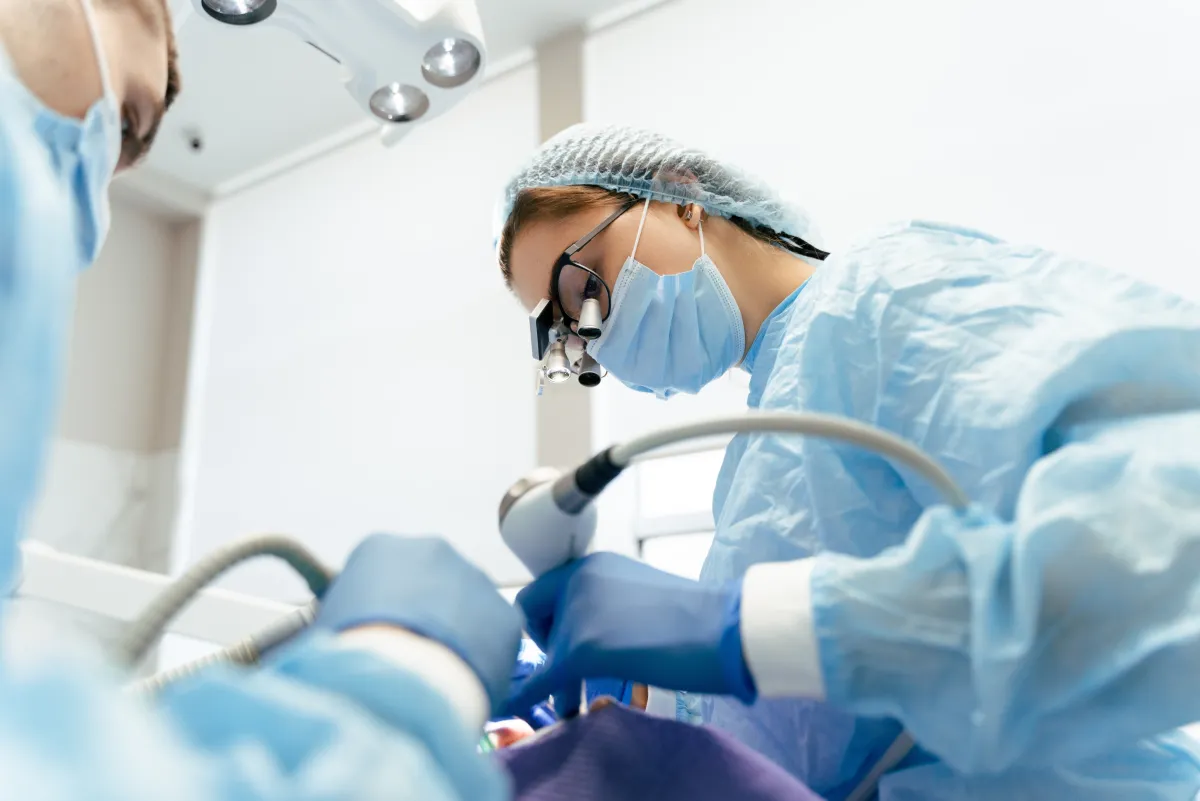 Dental surgeon performing a tooth extraction at Studio One Dental in Humble, TX
