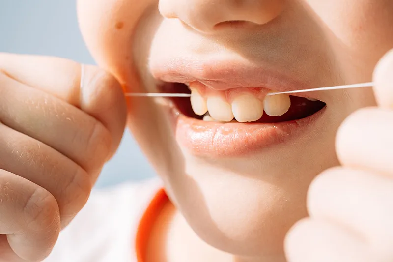 Child flossing at Studio One Dental